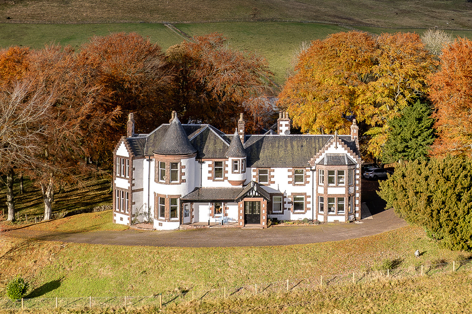 Exterior of Kinclune House with autumnal trees surrounding